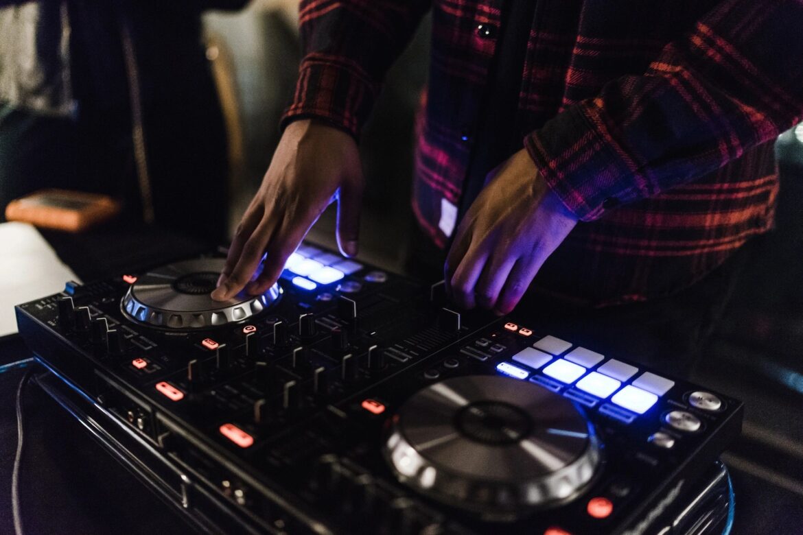 A person is playing some music on the dj equipment.