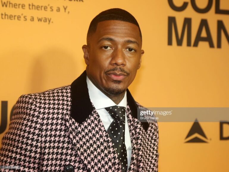 A man in a suit and tie standing next to a wall.