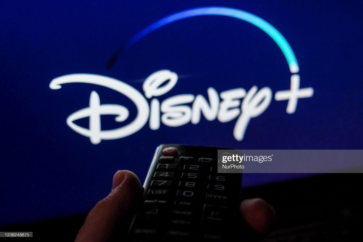 TV remote control is seen with Disney+ logo displayed on a screen in this illustration photo taken in Krakow, Poland on February 6, 2022. (Photo by Jakub Porzycki/NurPhoto via Getty Images)