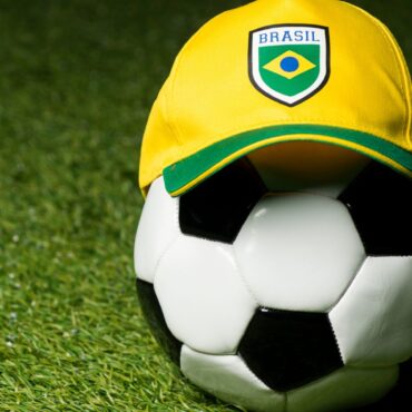 A soccer ball with a yellow and green hat on it.