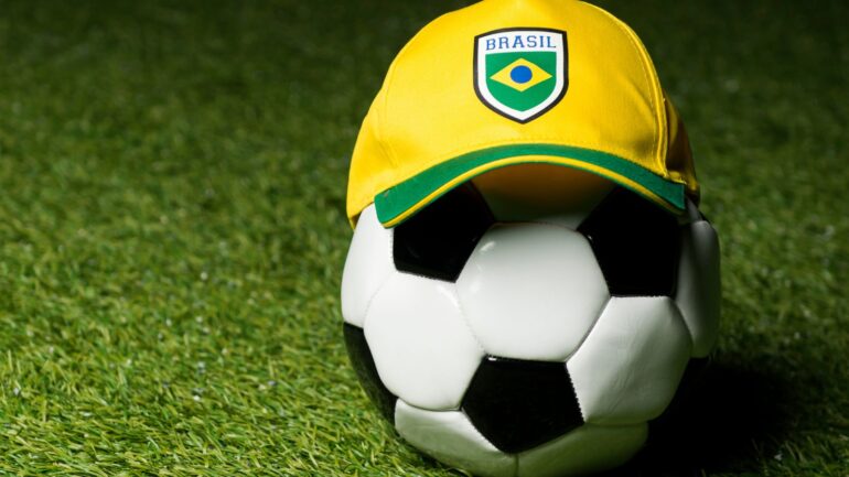 A soccer ball with a yellow and green hat on it.