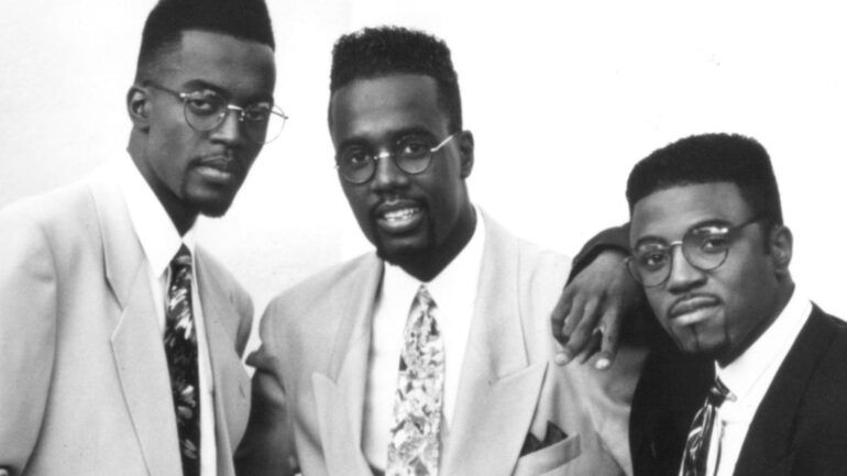 A black and white photo of three men in suits.