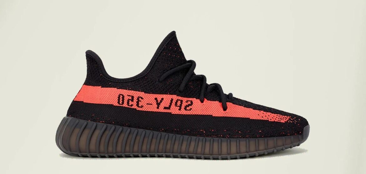 A black and orange Yeezy Boost 350 V2 sneaker.